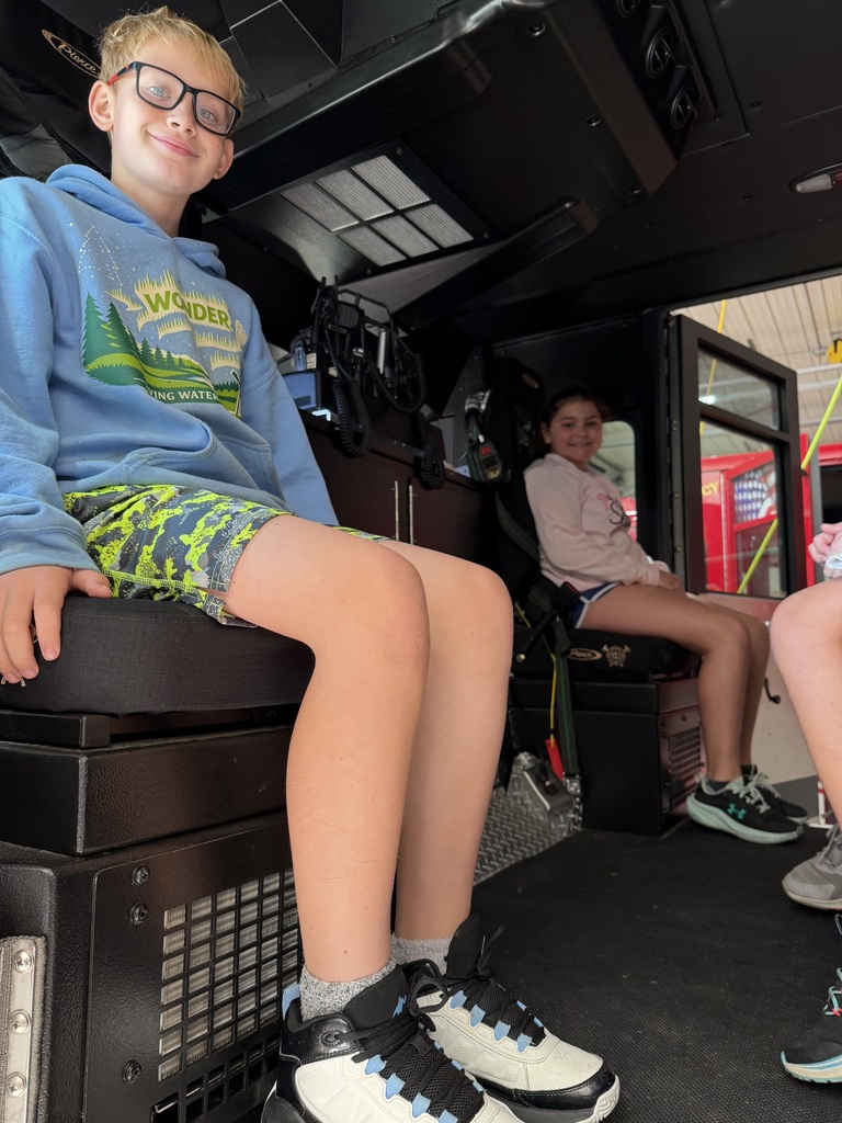 students sit in a fire truck