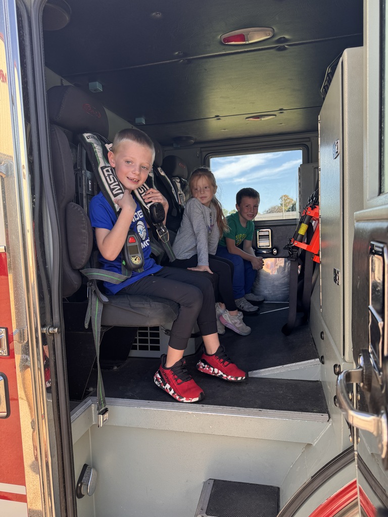 students sit in a fire truck