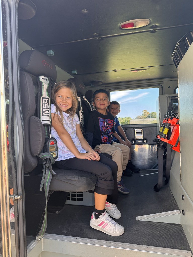 students sit in a fire truck