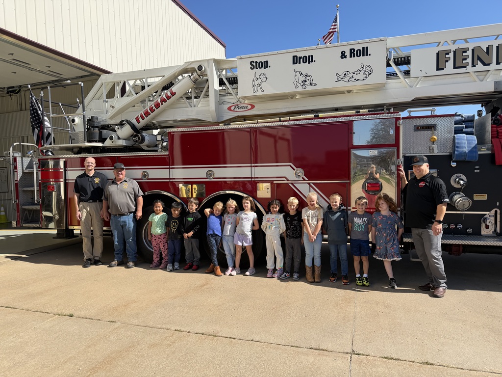5K students pose for a picture with firefighters in front of fire engine