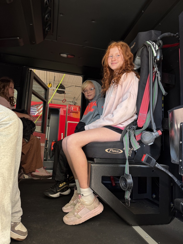 students sit in a fire truck