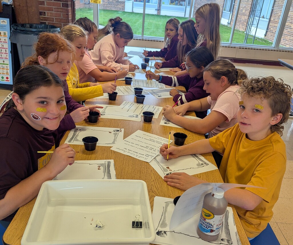 students write on scrolls