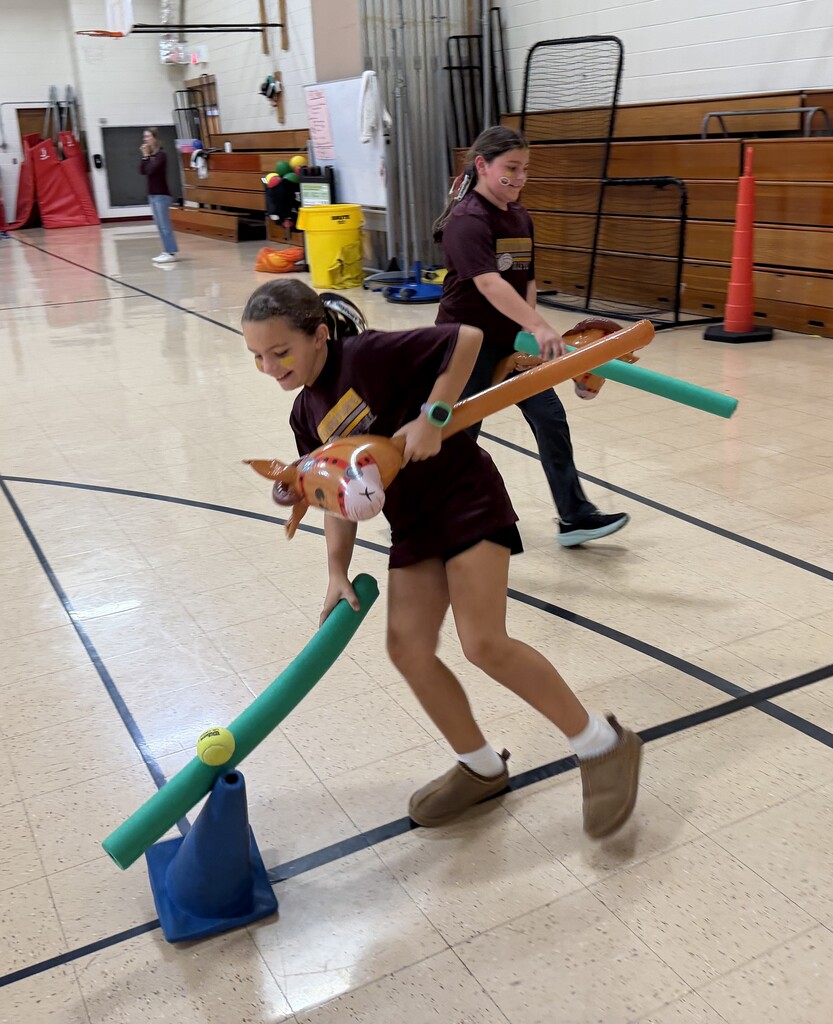 students do jousting in the gym