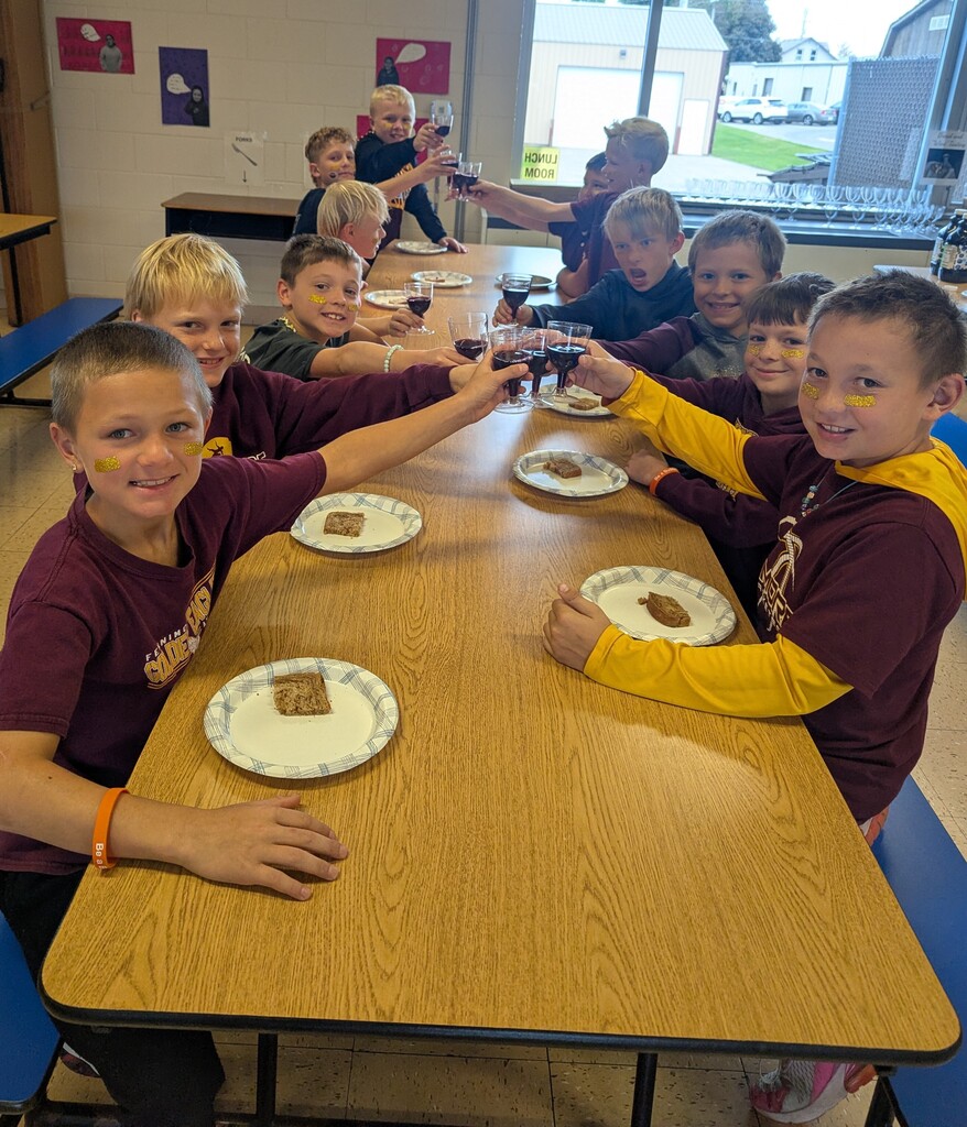 students share a snack of rye bread and juice
