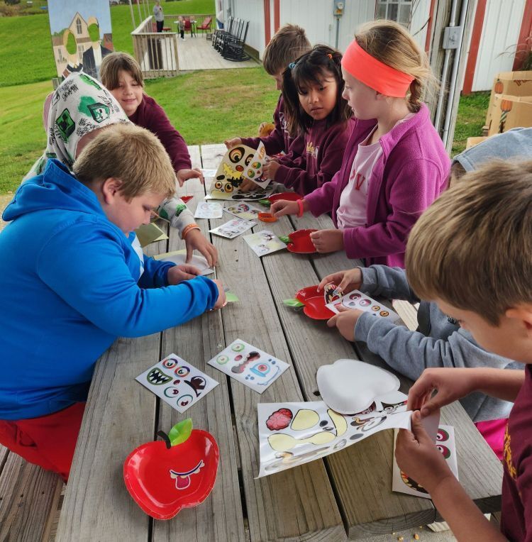 students make a craft at the apple orchard