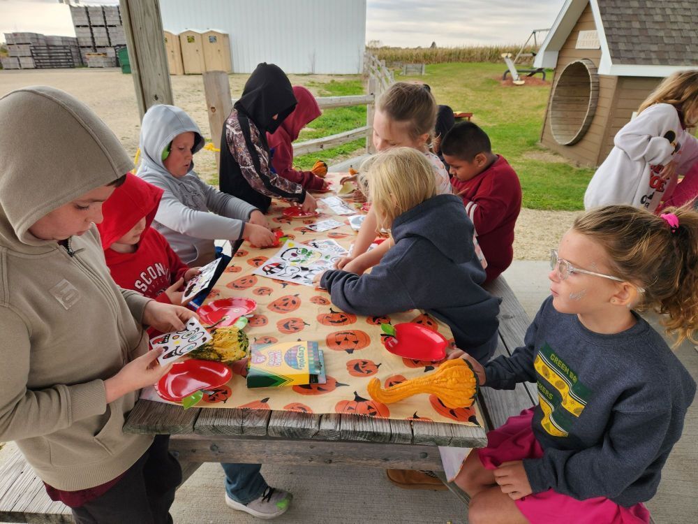 students make a craft at the apple orchard