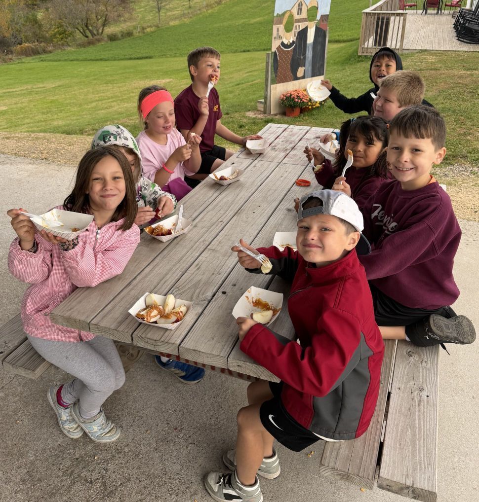 students eat their carmel apple sundae at the apple orchard