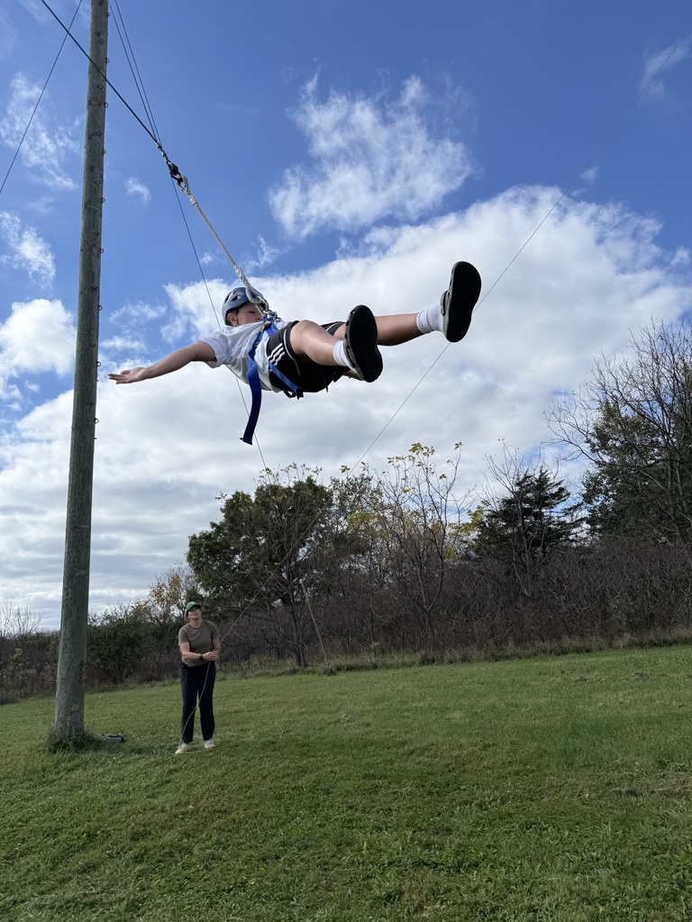 a student is in the harness at bethel horizons field trip and swinging