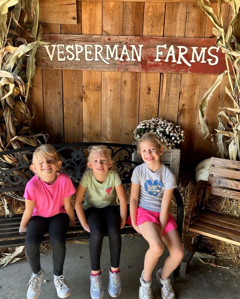 students pose for a pic on a bench at Vesperman farms