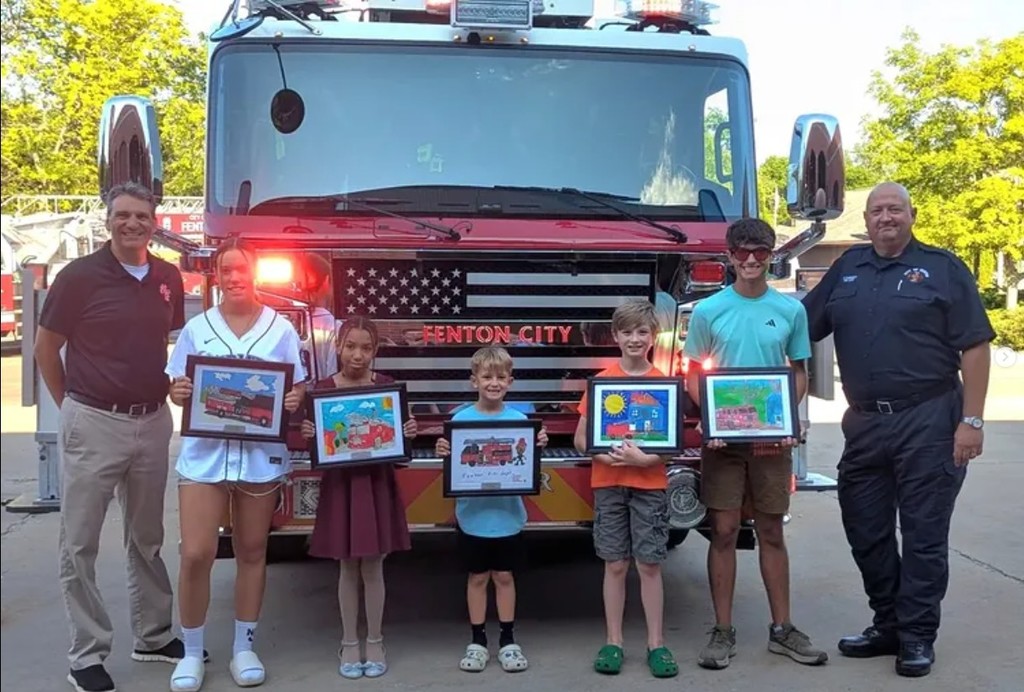 Students standing in front of a fire truck