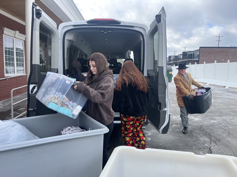 FHS student unloading a van full of donations to Carriage Town Ministries in Flint, MI.