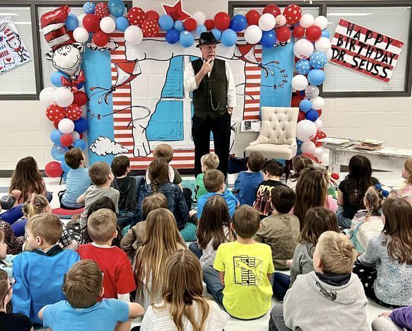teacher speaking in front of students.