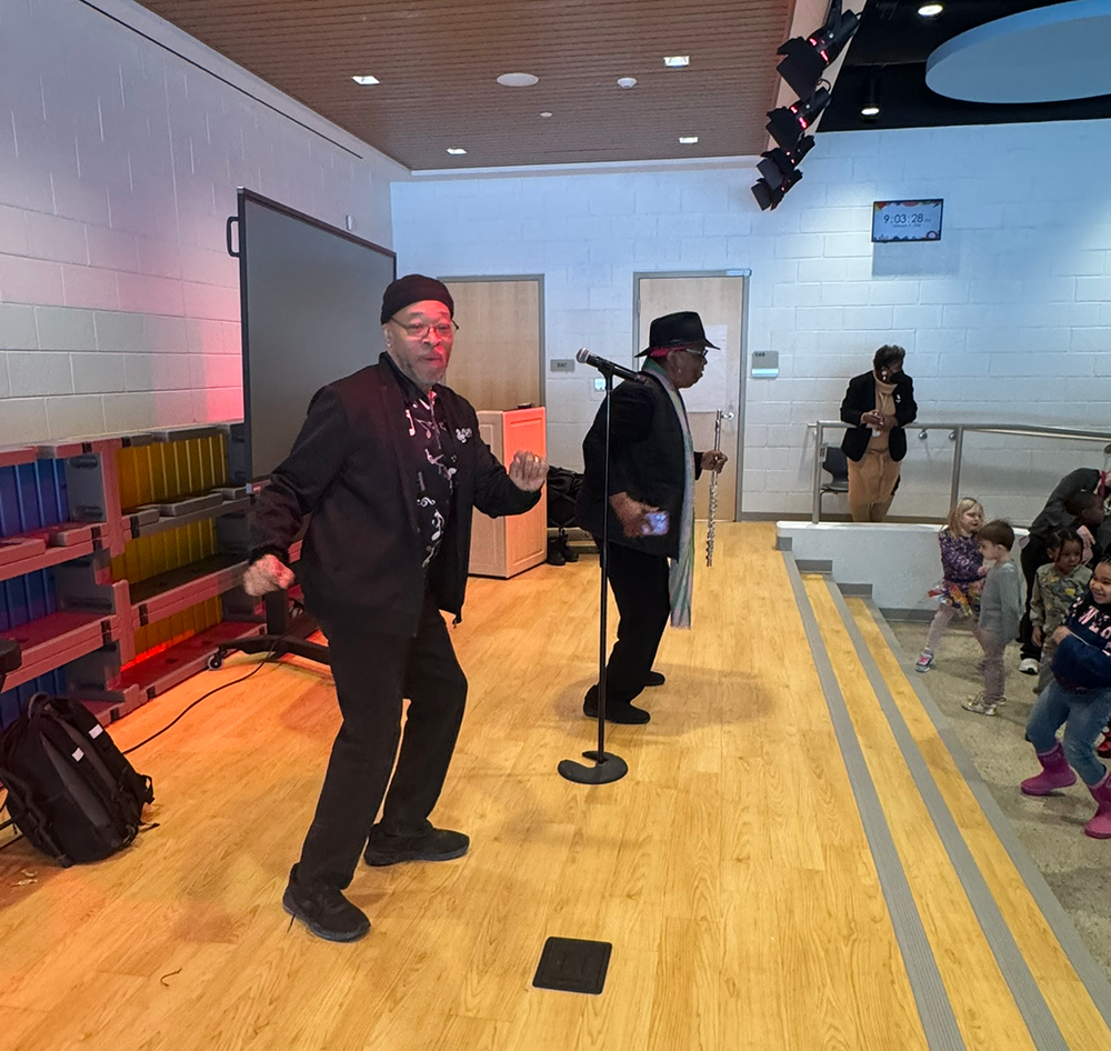 performers dance on stage in Ferndale Lower Elementary audi-teria