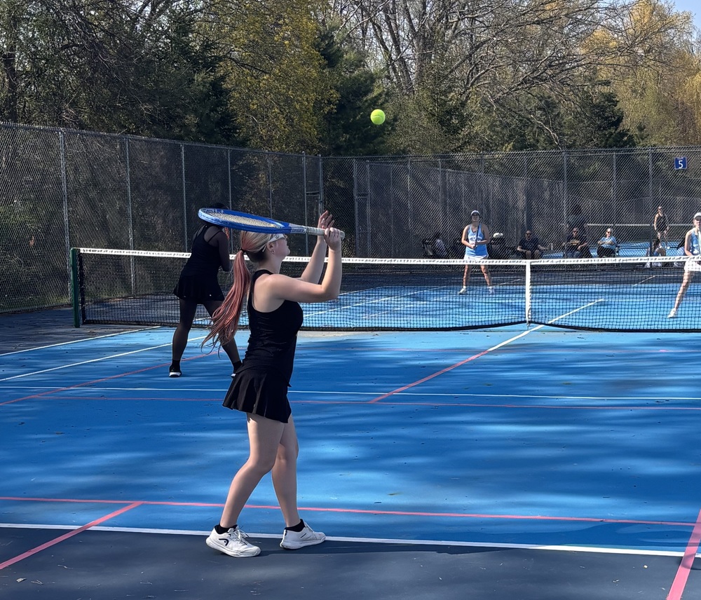 girls tennis plays a match