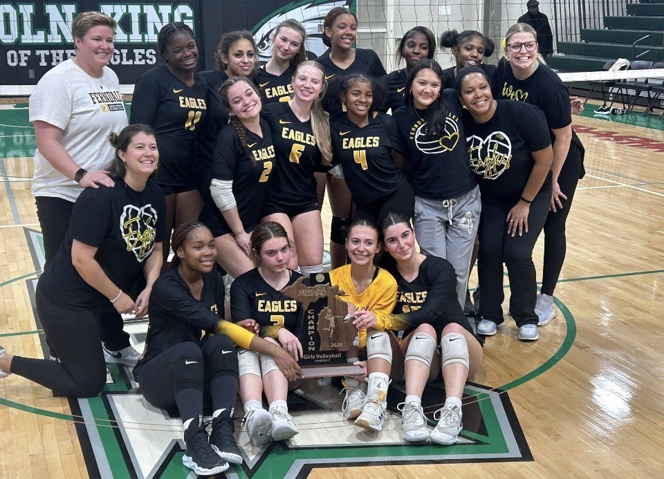 volleyball team poses with regional trophy