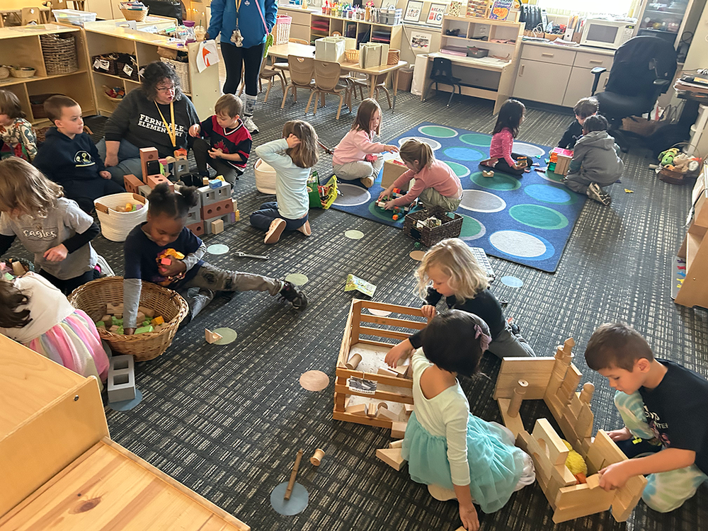 preschool children collaborate while practicing construction skills