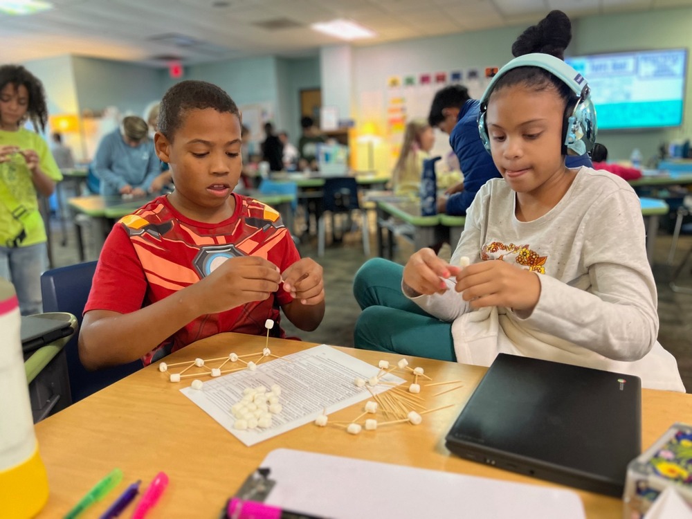 students engineer structures with toothpicks and marshmallows