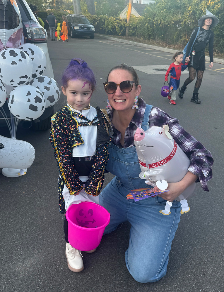 Farmer Schmidt poses with a student at trunk or treat