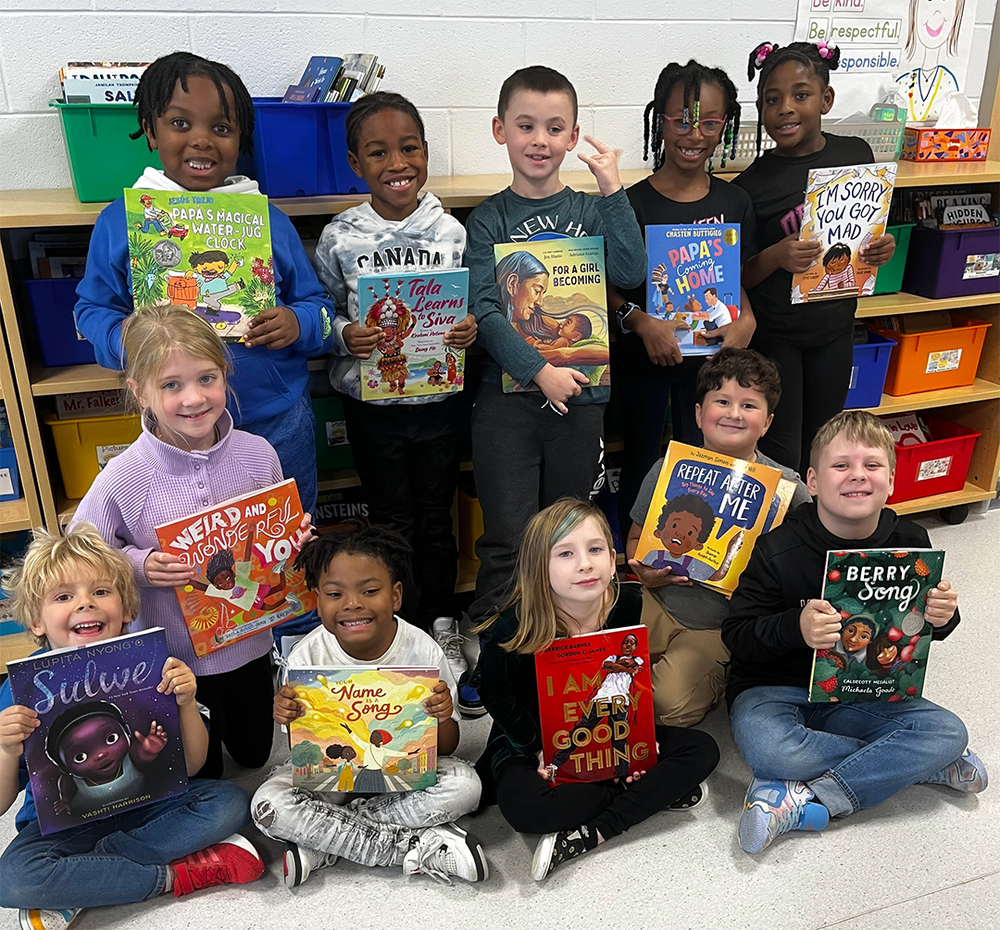 2nd graders show of their new book collection of diverse stories