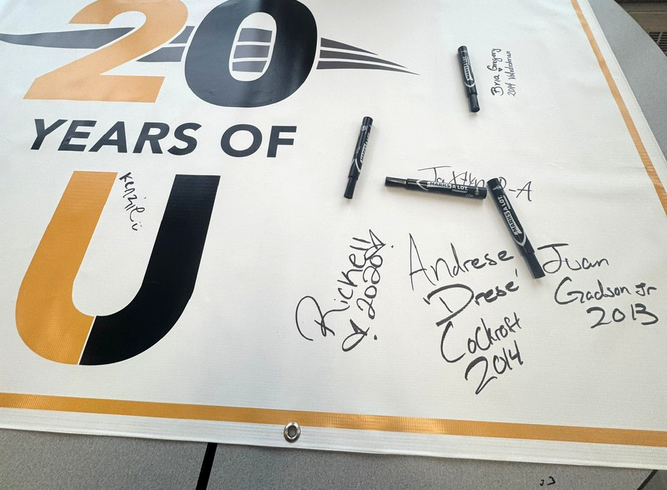 20 years of UHS banner with alumni signatures