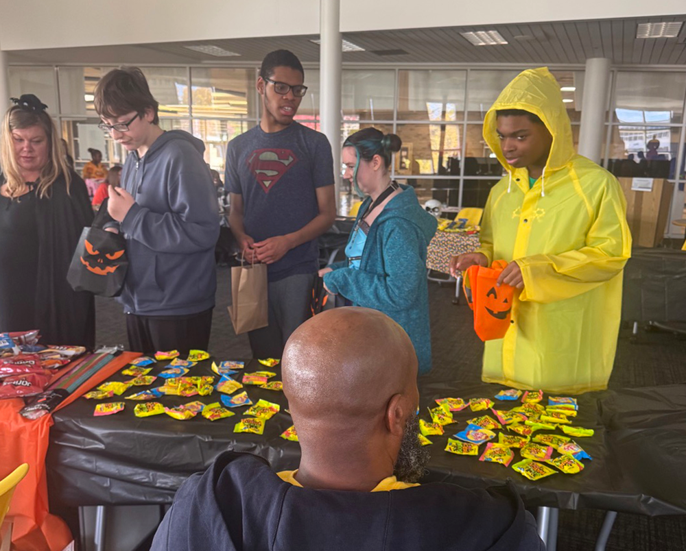 students collect candy and treats in the nest during Harvest Festival.