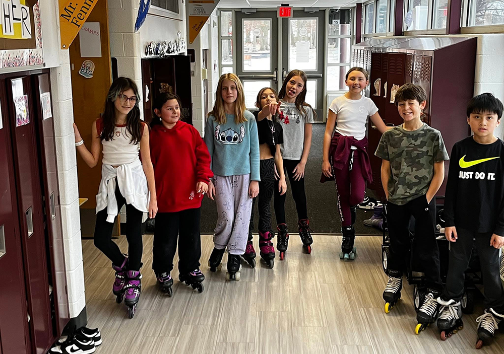 FUEL students rollerblading in the hallway