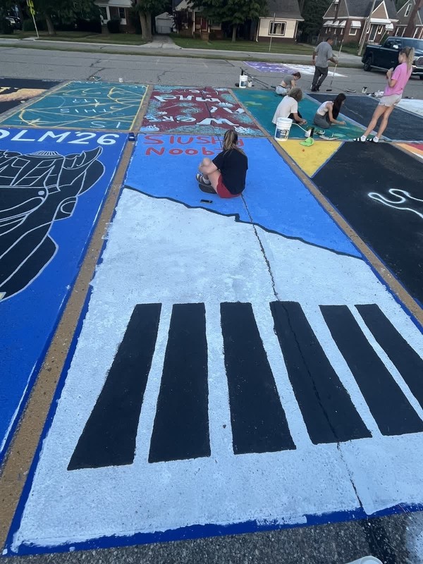 seniors paint parking spaces