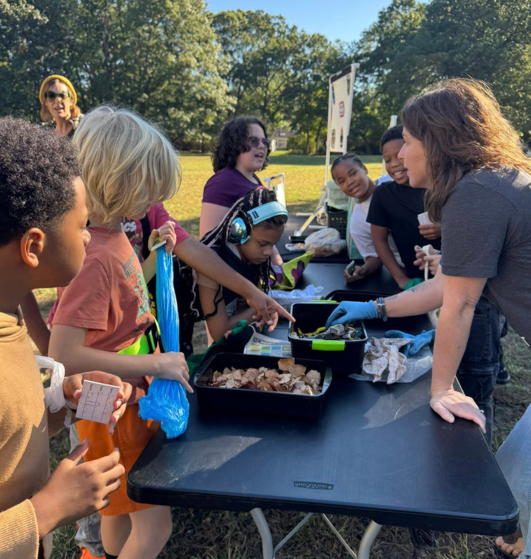 Students learn about plant science around a table at the FUEL Farmers Market