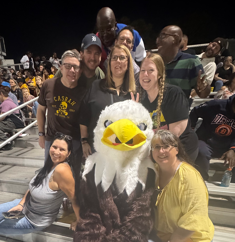 eagle mascot in the stands with neighbors