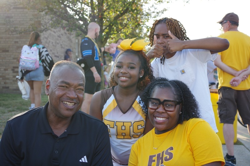 community members pose at homecoming tailgate