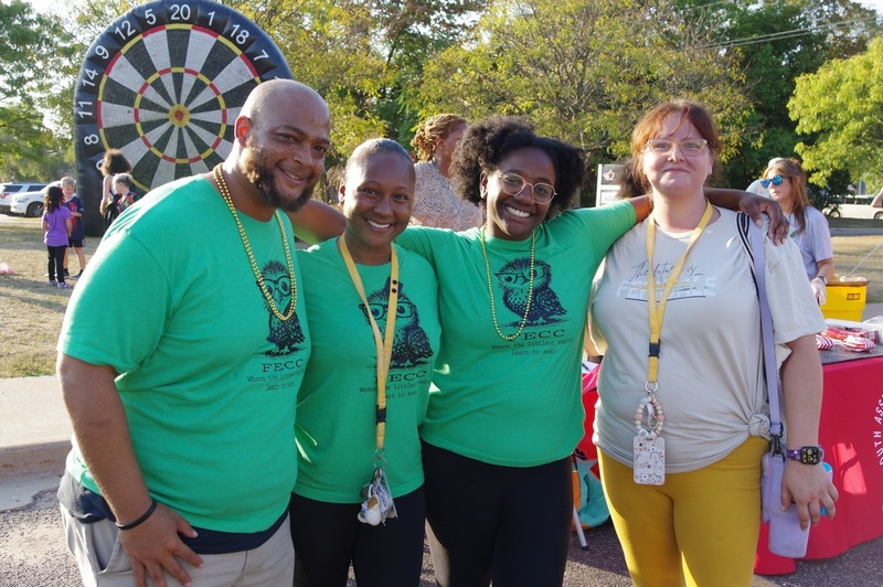 volunteers stand together at homecoming tailgate