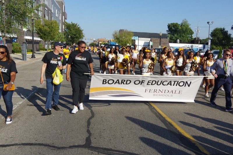 community marches in homecoming parade