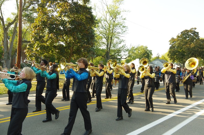 community marches in homecoming parade