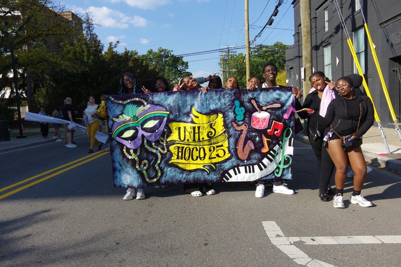 community marches in homecoming parade