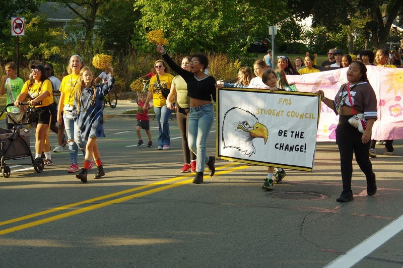 community marches in homecoming parade