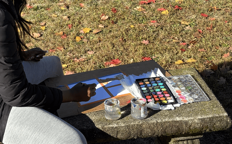Students use watercolors to paint colorful fall leaves in the Ferndale High  School courtyard