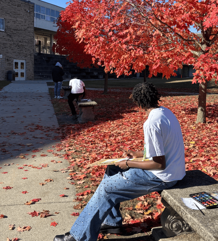 Students use watercolors to paint colorful fall leaves in the Ferndale High  School courtyard
