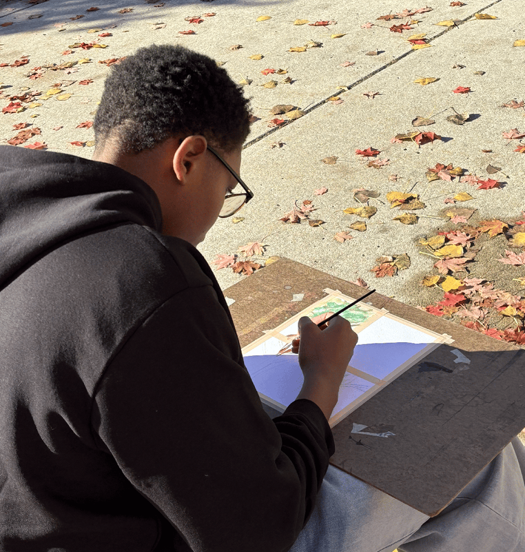 Students use watercolors to paint colorful fall leaves in the Ferndale High  School courtyard