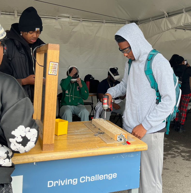 students practice driving screws with a cordless driver