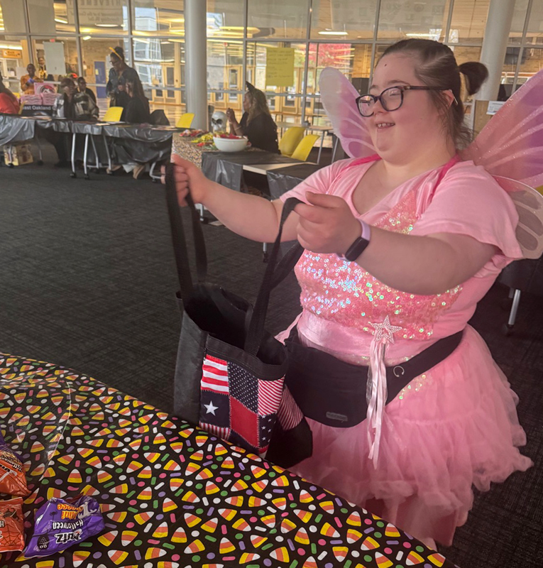 students collect candy and treats in the nest during Harvest Festival.