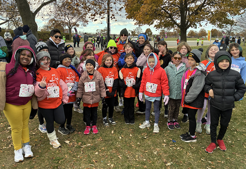 runners pose after competition on Belle Isle