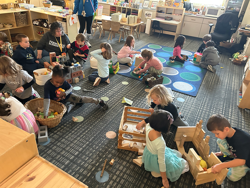 preschool children collaborate while practicing construction skills
