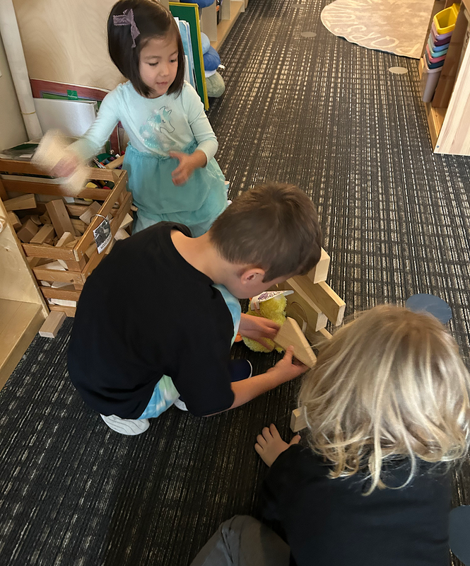 preschool children collaborate while practicing construction skills