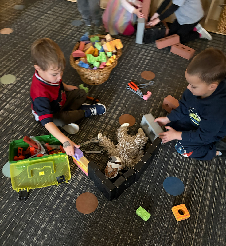 preschool children collaborate while practicing construction skills