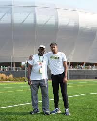 Jaydin and coach george stand together