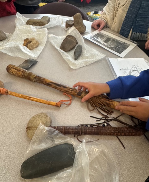 students explore traditional hunting tools