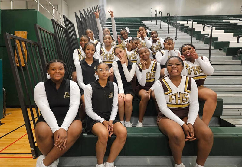 JV Cheer poses in the gym