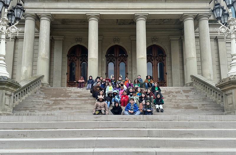 students on the steps of the capitol in Lansing
