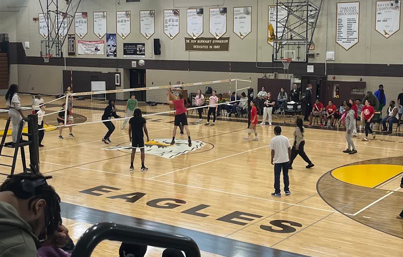 students compete against teachers in a volleyball fundraiser at FHS