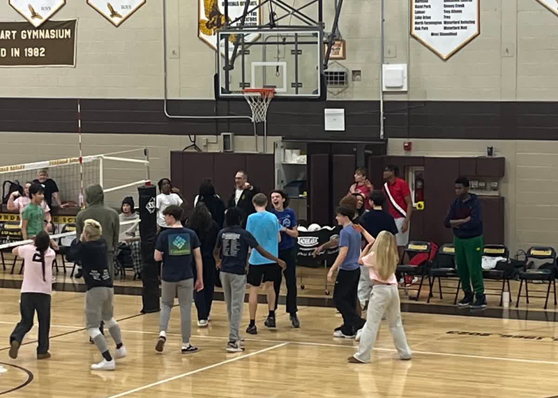 students compete against teachers in a volleyball fundraiser at FHS
